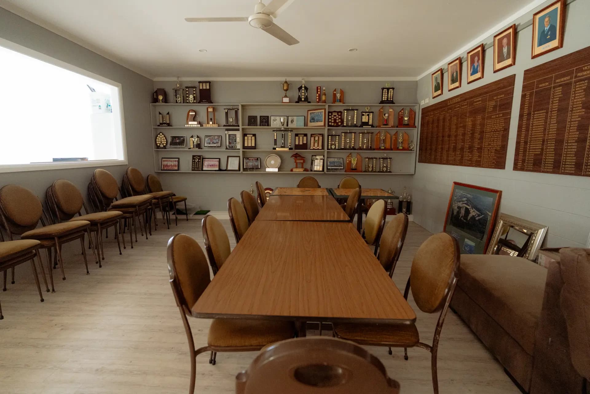 Honour boards, trophies and framed portraits in the clubhouse meeting room