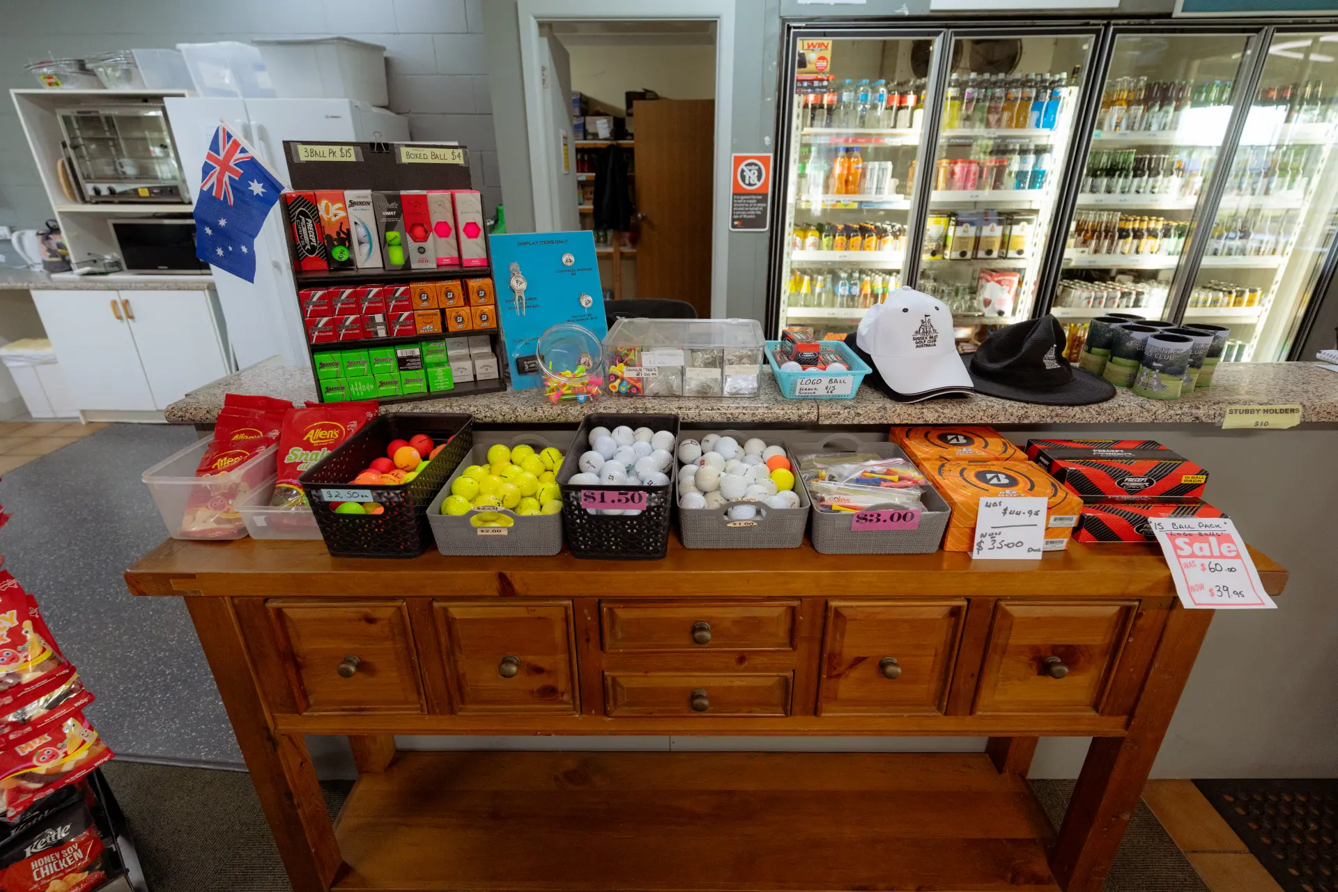 Golf balls, tees, caps and club merchandise laid out on the pro shop counter