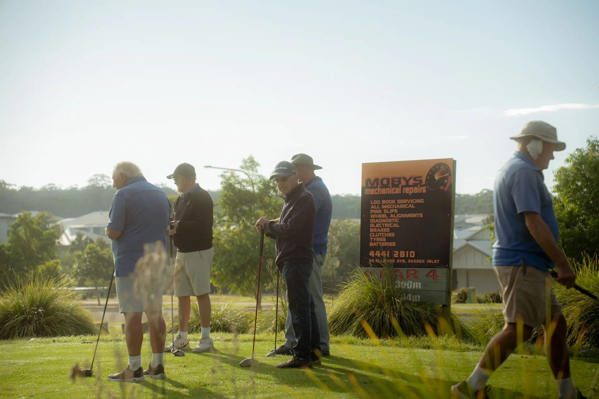 Sponsor boards beside a fairway at Sussex Inlet Golf Club