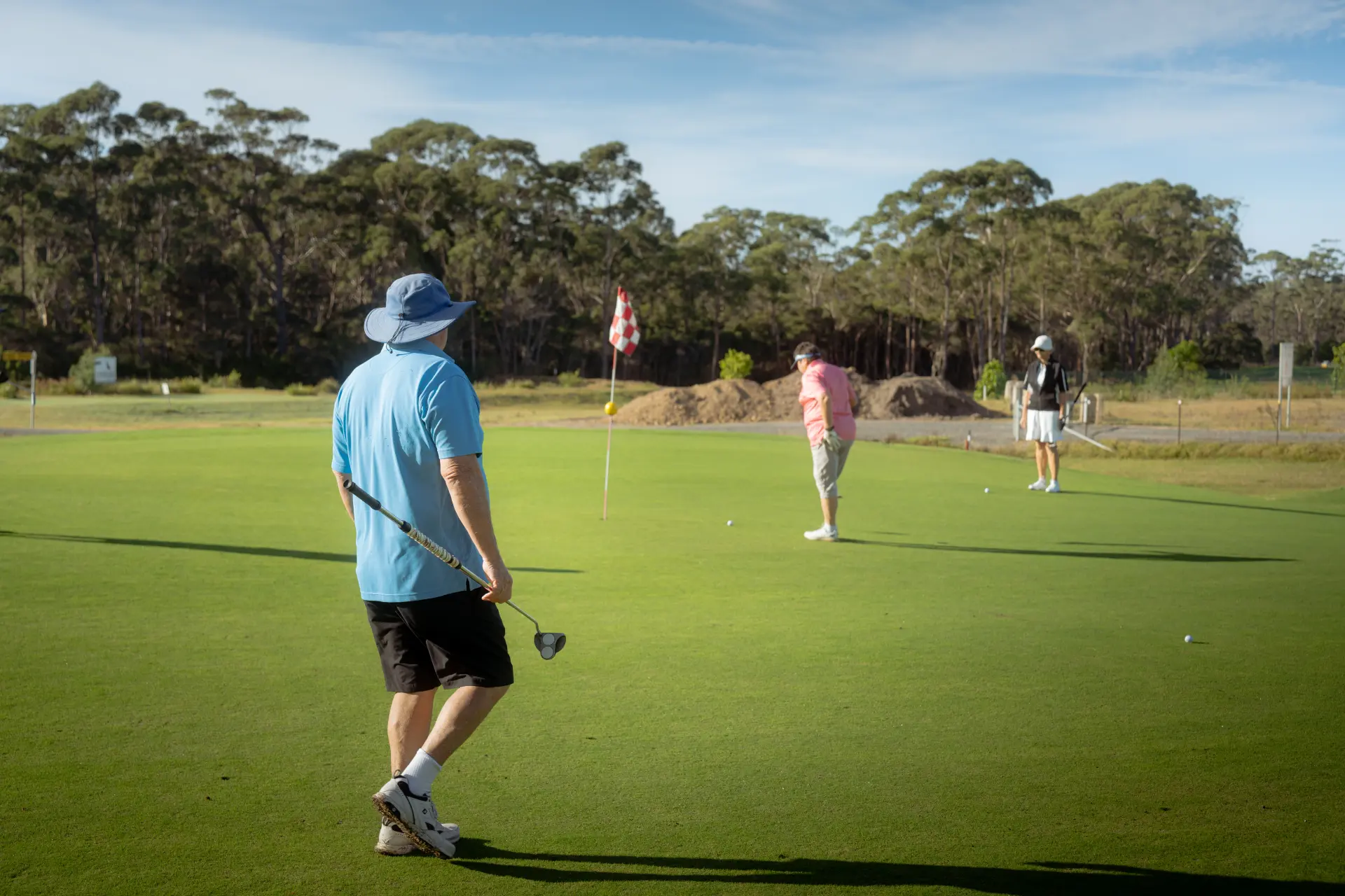 A fairway at Sussex Inlet Golf Club winding through native gum trees