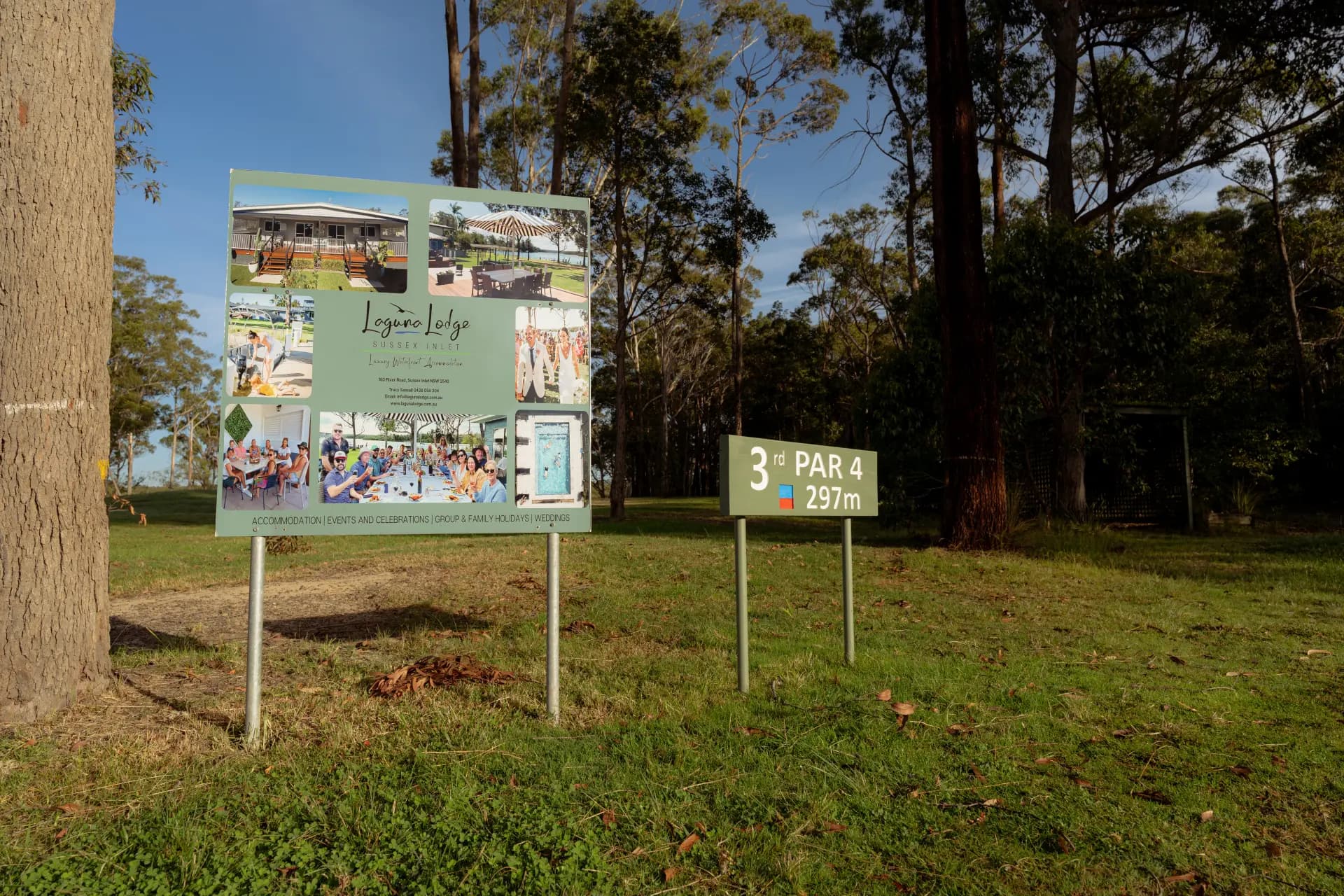 Sponsor signs from local businesses beside a fairway at Sussex Inlet Golf Club